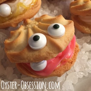 Lemon oyster cookies with pink frosting filling and sixlet pearl.