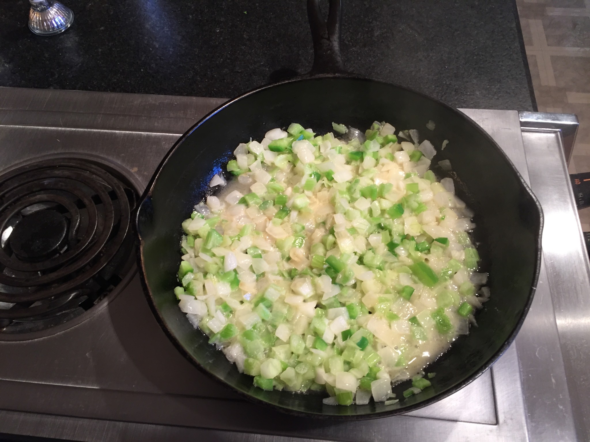 Cooking onions, peppers, and celery for dressing.